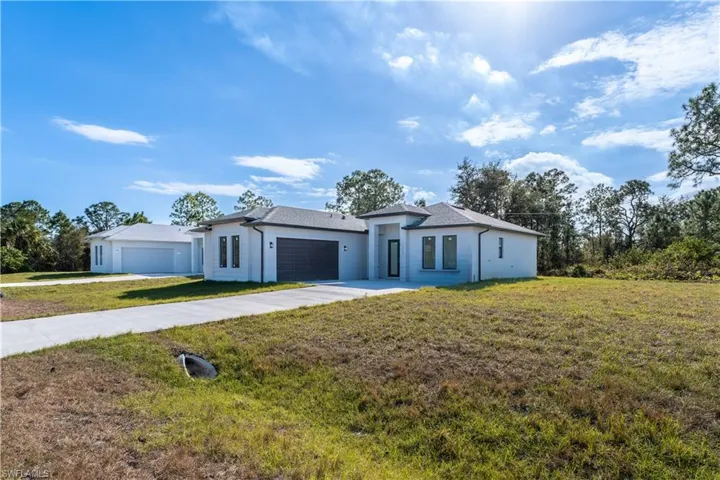 View of front of house featuring a front yard and a garage