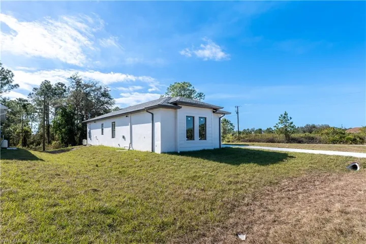 View of side of home featuring a yard