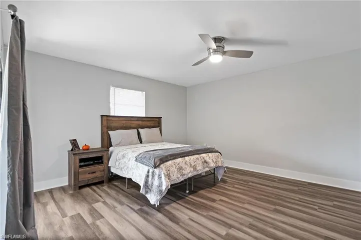 Bedroom with hardwood / wood-style flooring and ceiling fan