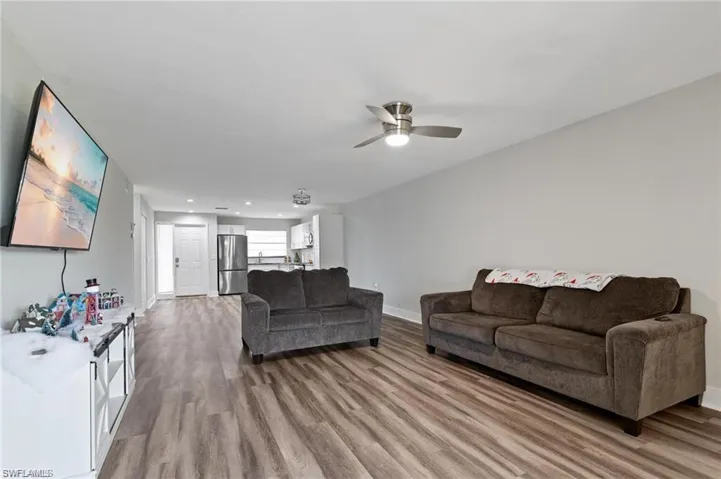 Living room featuring ceiling fan and hardwood / wood-style flooring