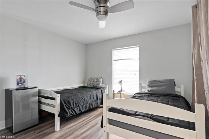 Bedroom featuring ceiling fan and hardwood / wood-style floors