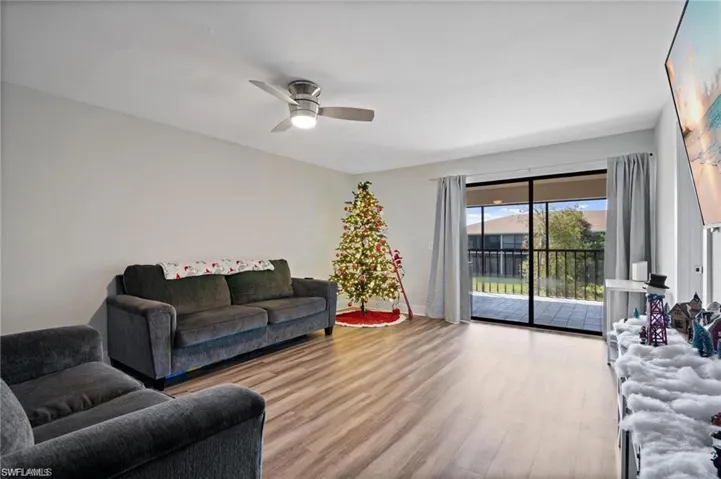 Living room featuring light hardwood / wood-style flooring and ceiling fan