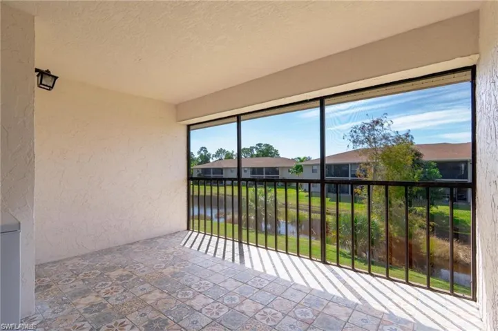 Sunroom / solarium featuring a water view