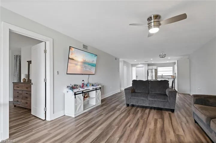 Living room featuring ceiling fan and hardwood / wood-style flooring