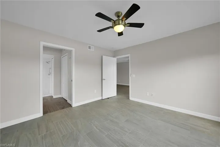 Unfurnished bedroom with ceiling fan