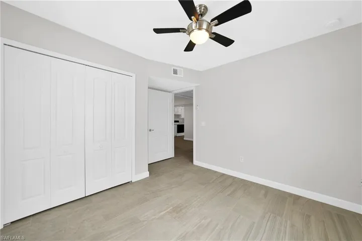 Unfurnished bedroom featuring light hardwood / wood-style flooring, ceiling fan, and a closet