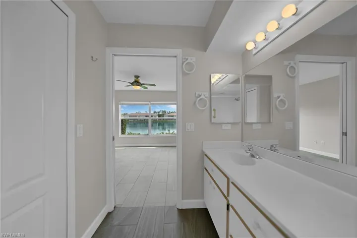 Bathroom with vanity, tile patterned floors, and ceiling fan