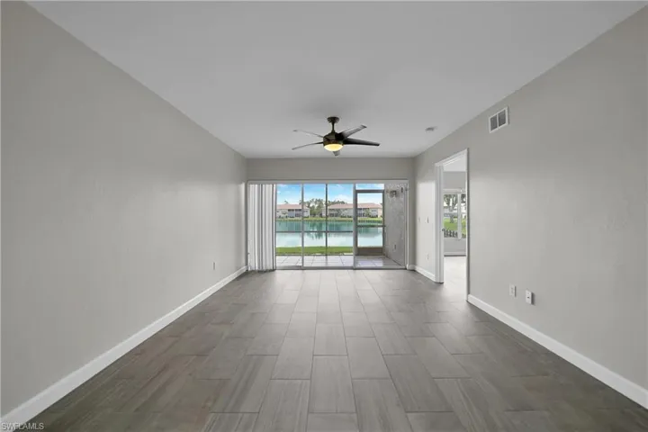 Spare room featuring a water view and ceiling fan