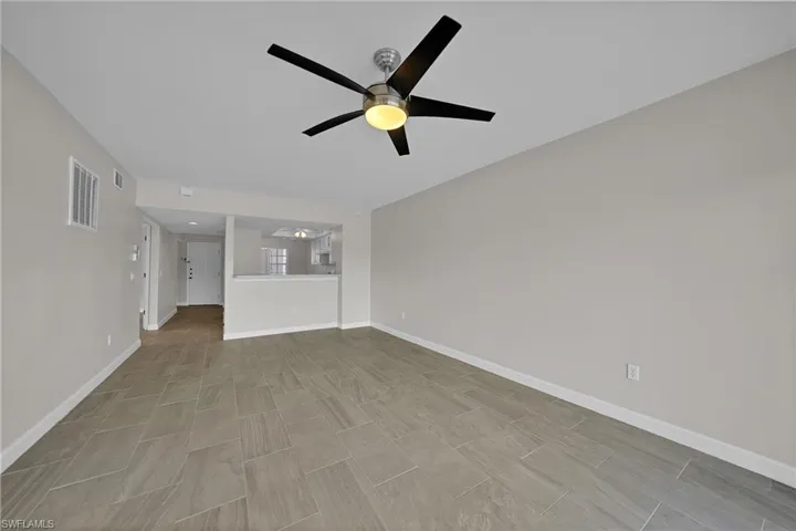 Unfurnished living room with ceiling fan