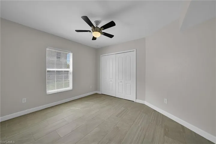 Unfurnished bedroom with light hardwood / wood-style floors, a closet, and ceiling fan