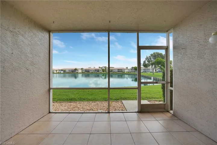 Unfurnished sunroom featuring a water view