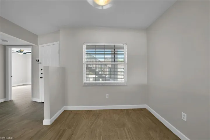 Spare room with ceiling fan and wood-type flooring