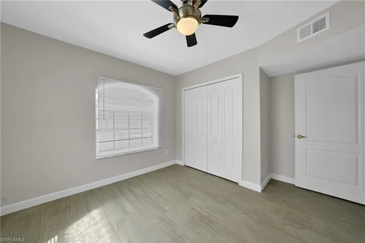 Unfurnished bedroom featuring a closet and ceiling fan