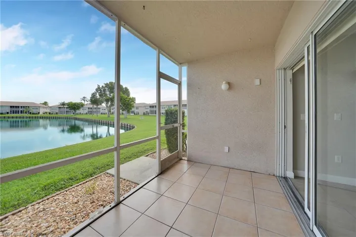 Unfurnished sunroom with a water view