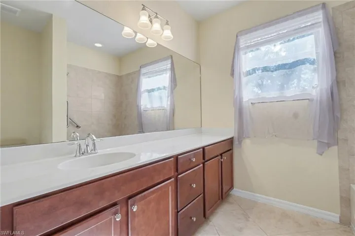 Bathroom with vanity and light tile patterned flooring