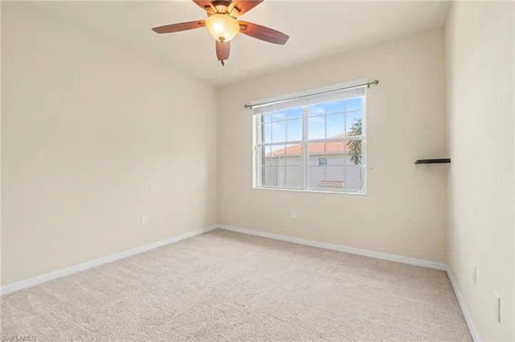 Spare room with light colored carpet and ceiling fan