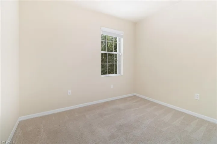 Spare room with carpet floors and baseboards