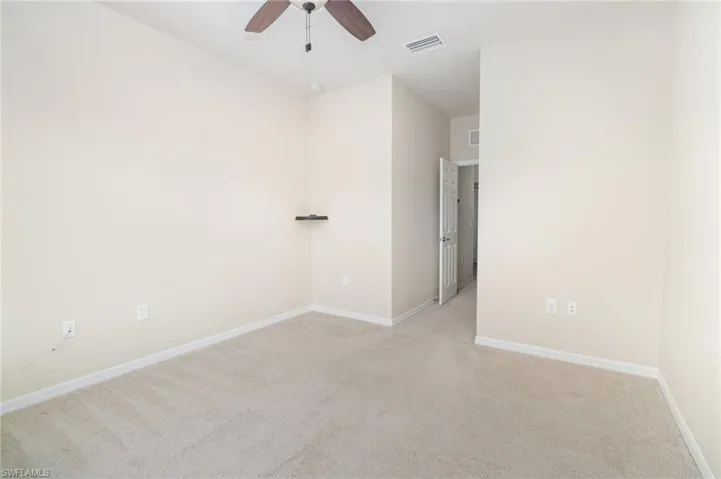Carpeted empty room with baseboards and ceiling fan