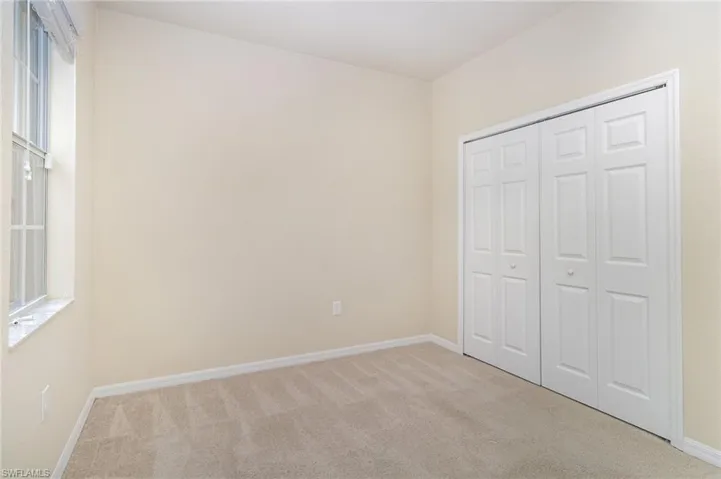 Unfurnished bedroom featuring carpet floors and a closet