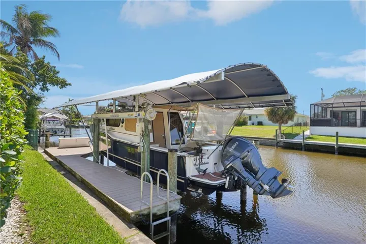 Dock featuring boat lift and a water view