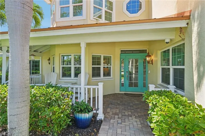 Doorway to property featuring stucco siding and a porch