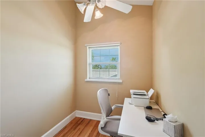 Office area featuring light wood-type flooring and a ceiling fan