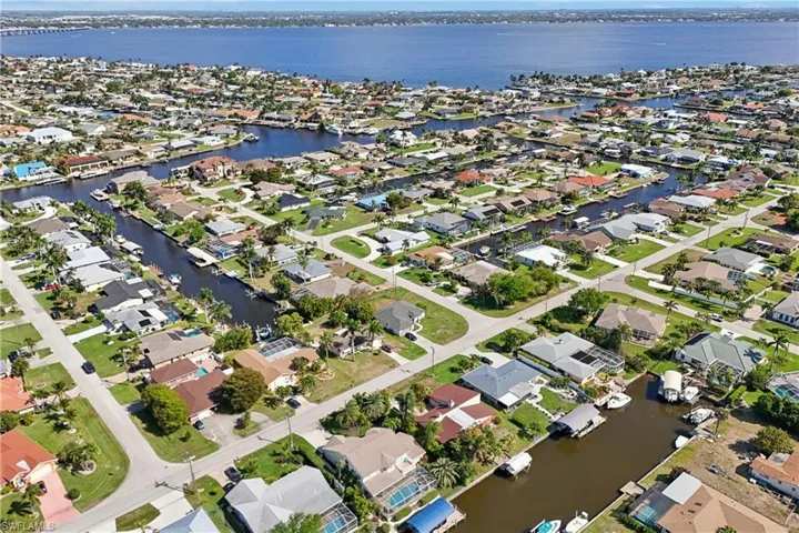 Aerial view of residential area featuring a large body of water