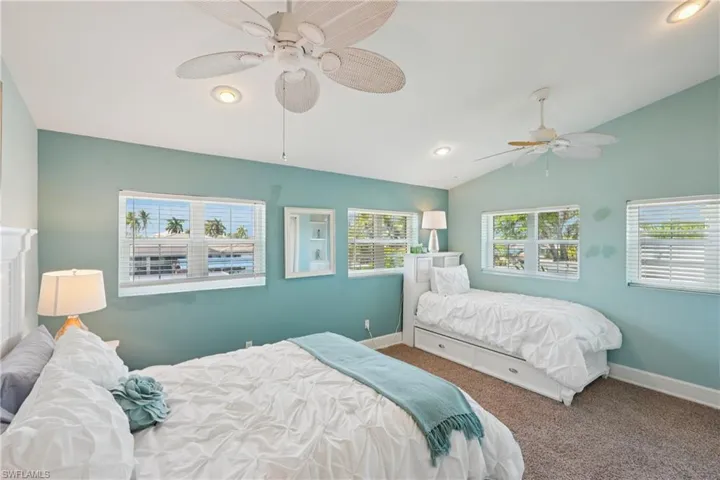 Carpeted bedroom featuring lofted ceiling, recessed lighting, and ceiling fan