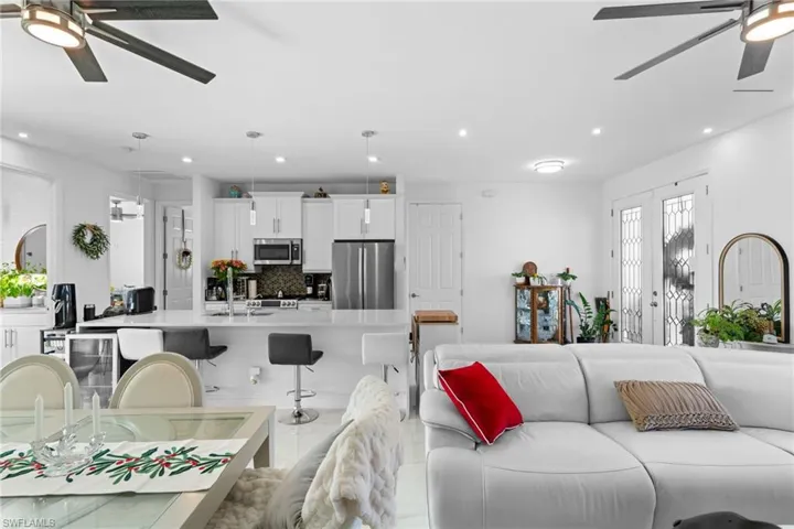 Living area featuring ceiling fan, wine cooler, and recessed lighting