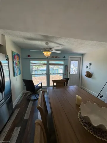 Dining space featuring a textured ceiling, wood finished floors, and ceiling fan