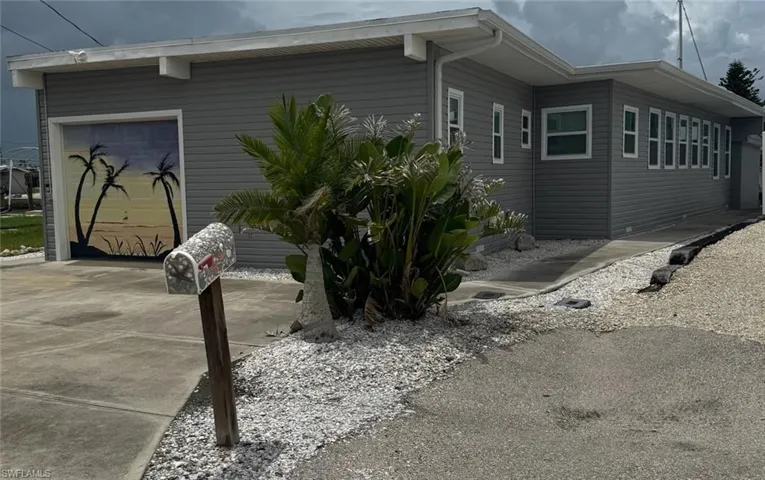 View of home's exterior with concrete driveway and a garage