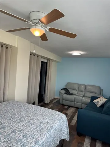 Bedroom featuring wood finished floors and a ceiling fan