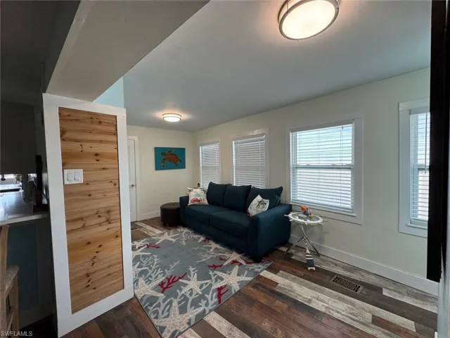 Living room featuring wood finished floors and baseboards