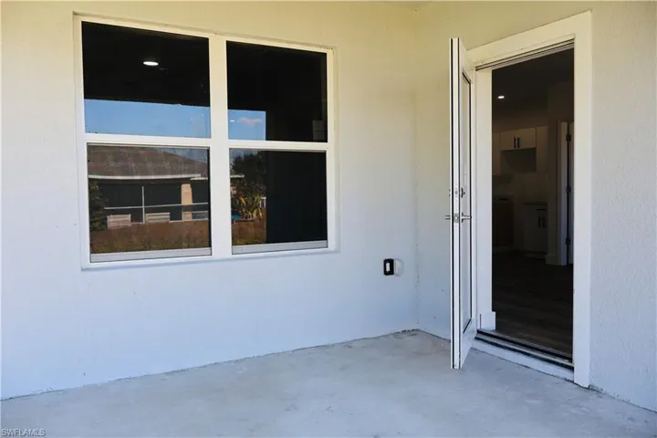 Entrance to property with a patio area and stucco siding