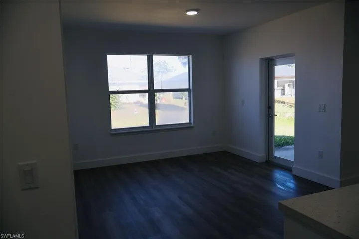 Spare room with dark wood finished floors and recessed lighting