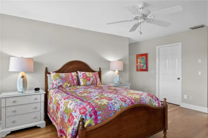 Primary Bedroom with light wood finished floors and a ceiling fan