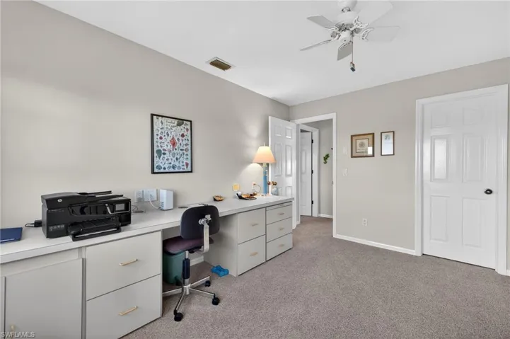 Bedroom/Office space featuring a ceiling fan and light colored carpet
