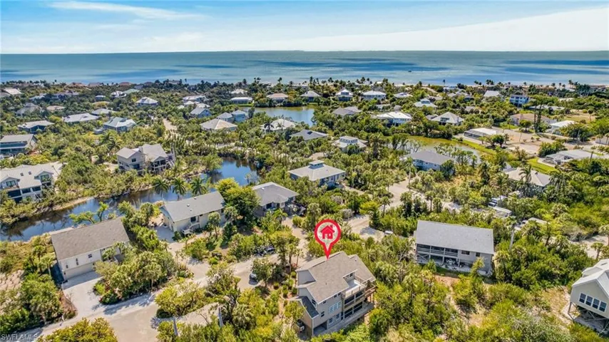 Aerial view of residential area featuring a large body of water