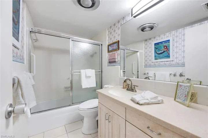 Features a tub/shower combo.