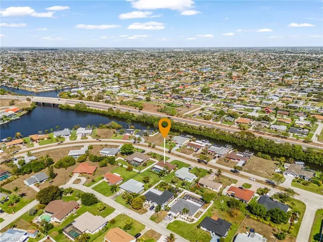 Aerial perspective of suburban area with a notable bridge and view of gulf access canals