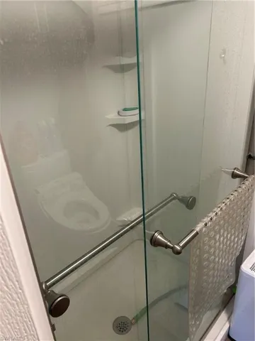 Full bath featuring a shower stall