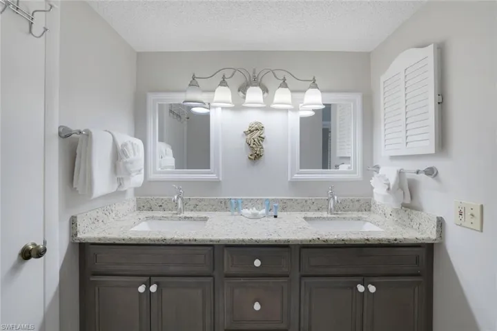 Bathroom with vanity and a textured ceiling