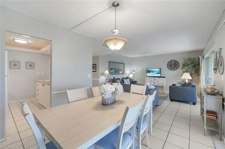 Dining space featuring light tile patterned flooring