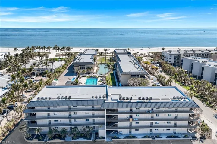Drone / aerial view with a water view and a view of the beach