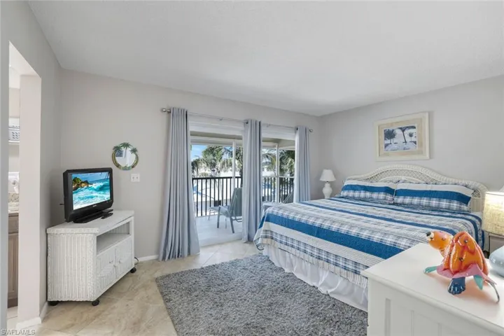 Bedroom with access to exterior and light tile patterned floors