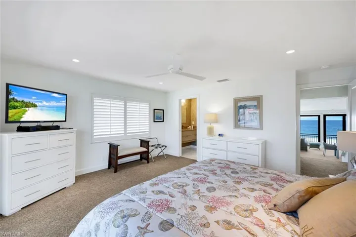 Bedroom featuring light carpet, a ceiling fan, and recessed lighting