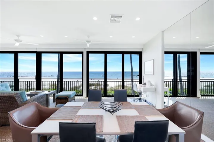 Dining area featuring a water view, recessed lighting, plenty of natural light, and carpet flooring