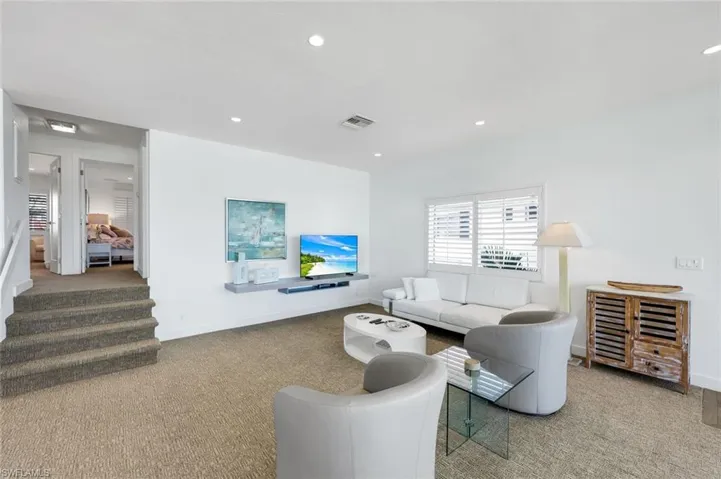 Living room with carpet floors and recessed lighting