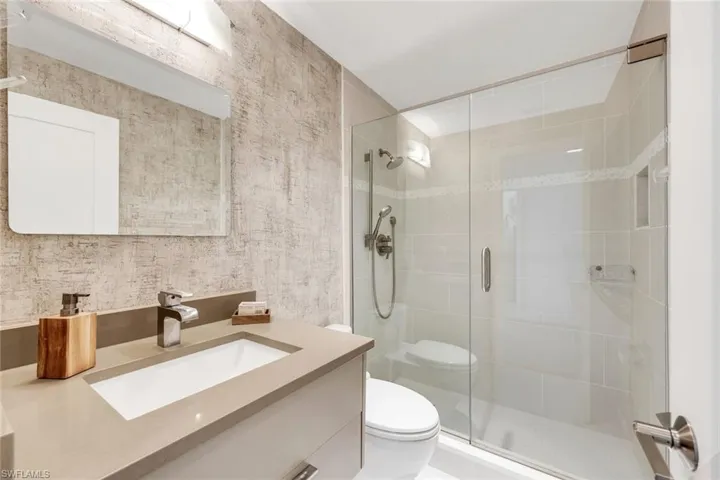 Full bath featuring vanity and a shower stall