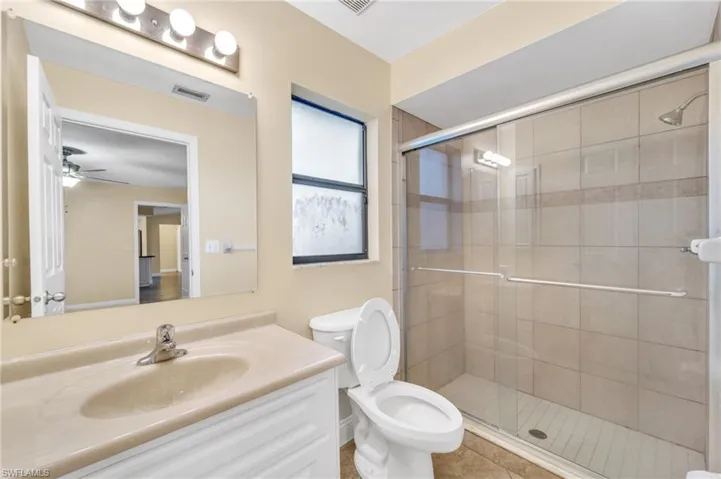 Full bath featuring vanity and a shower stall
